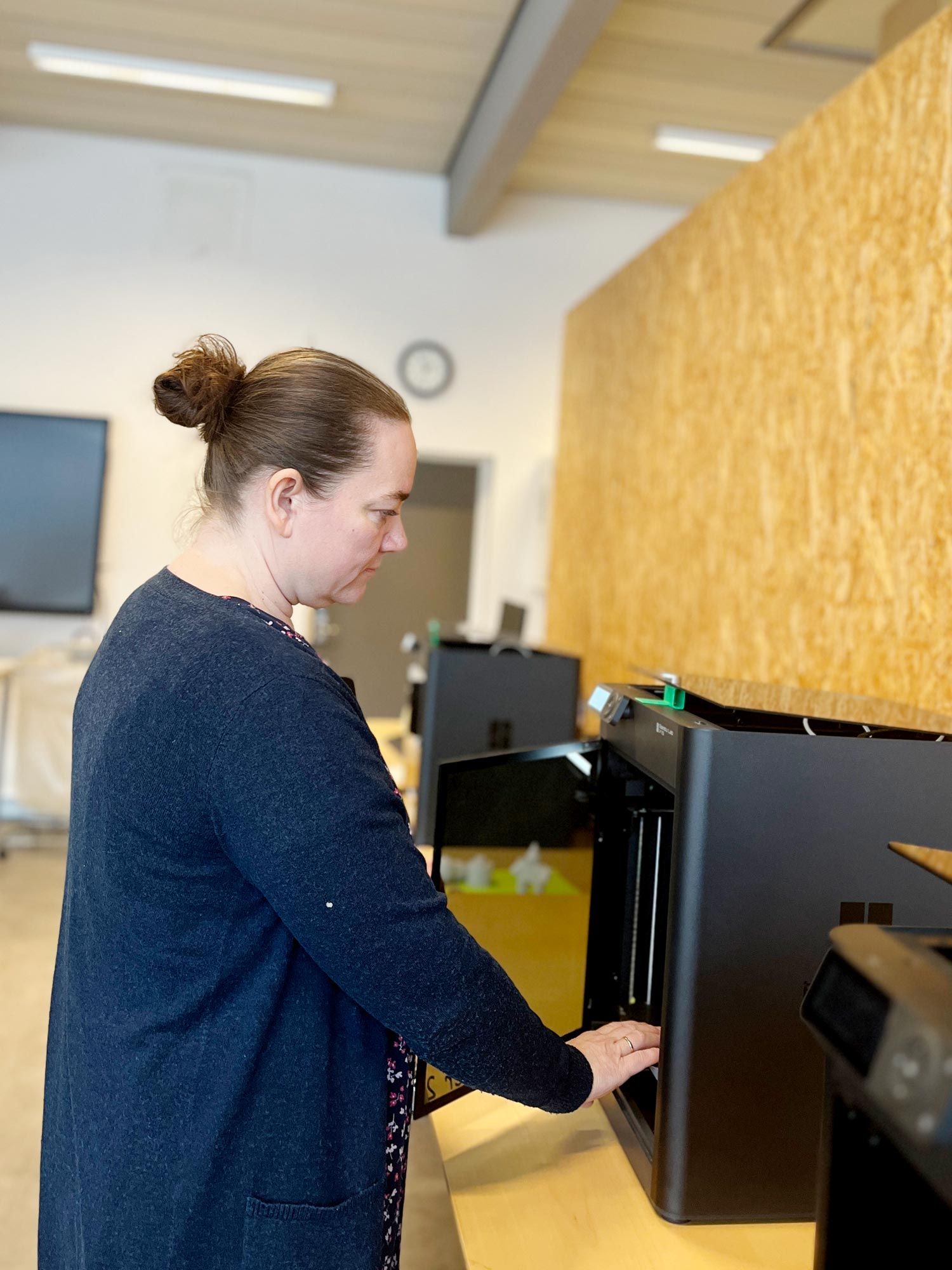 Lærer Mai-Britt Løndal Nielsen fixer en 3D-printer.
