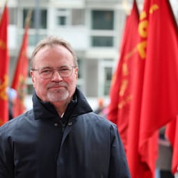 Gordon Ørskov Madsen omgivet af røde faner