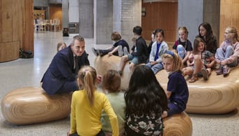Jakob Næsager sidder i en aula med små børn